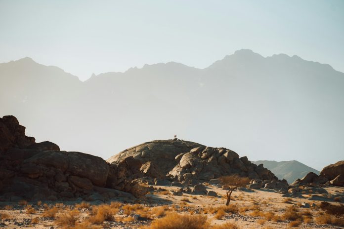 a person standing on top of a rocky hill